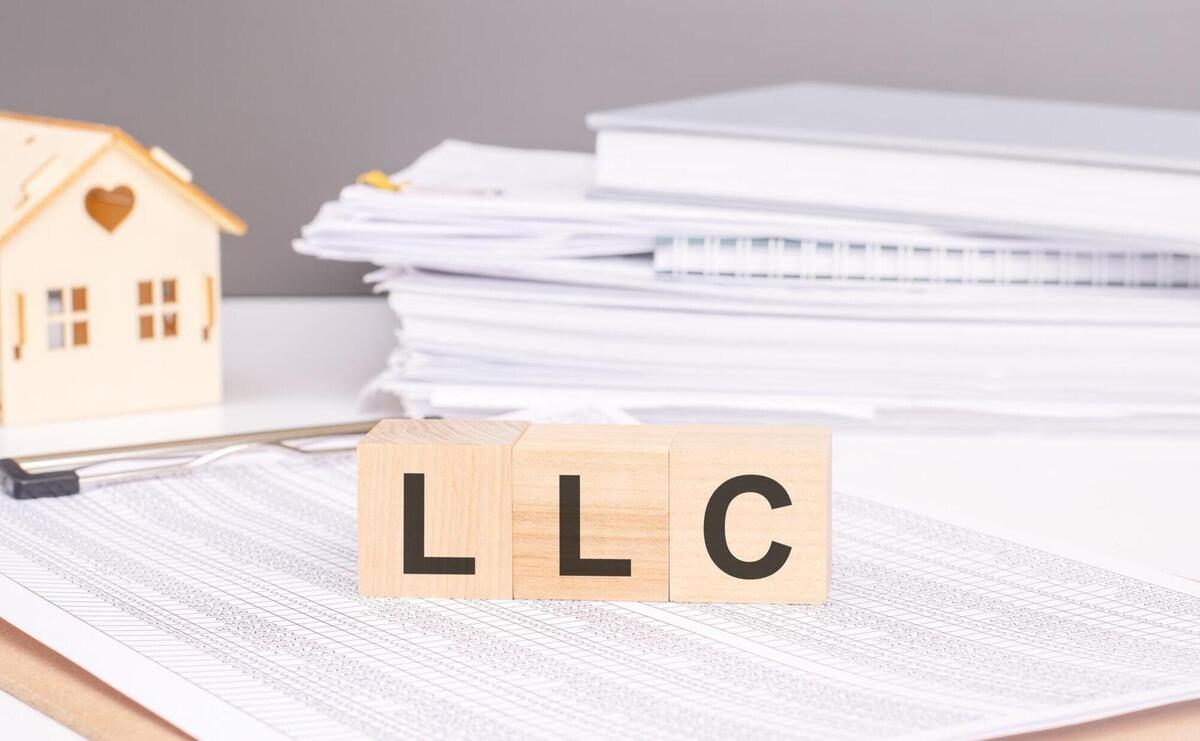 LLC business and technology concept text on wooden cubes