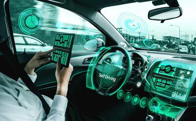 Self-drive autonomous car with man at driver seat.